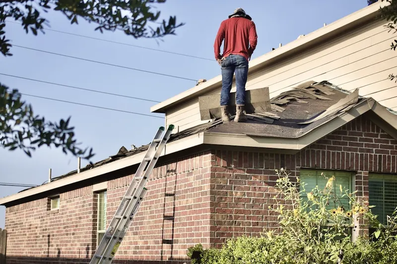 Professional roofer working on a residential roof in Roosevelt